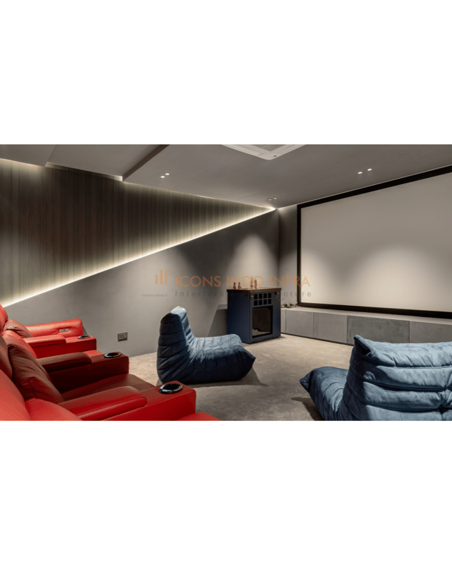Home theatre with tiered red leather recliners, blue Togo floor loungers, projector screen and warm cove lighting