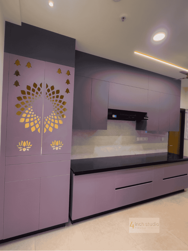 Mauve modular kitchen with gold lotus jali pooja unit, black granite counter and glossy cabinets, Hyderabad